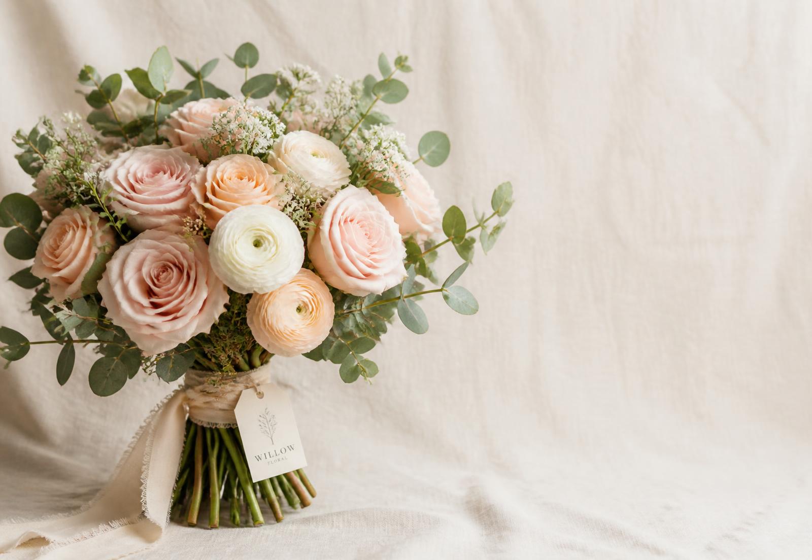 Blush rose and eucalyptus bouquet tied with silk ribbon